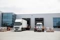 Box truck and cargo van at commercial loading dock with workers loading freight pallets - Ziggy Zion Transport general freight service